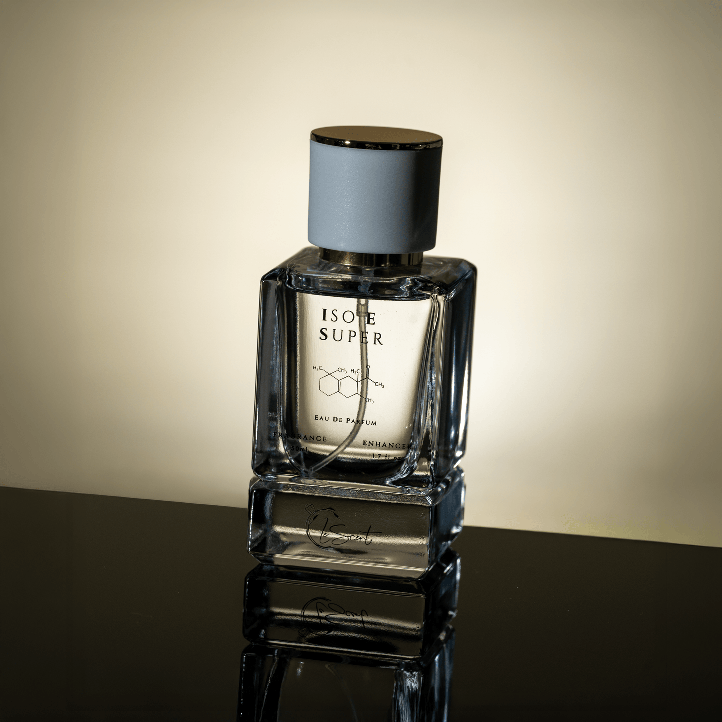 LeScent ISO E Super perfume bottle with gold cap reflecting light on a glossy surface, showcasing its minimalist design and premium craftsmanship.