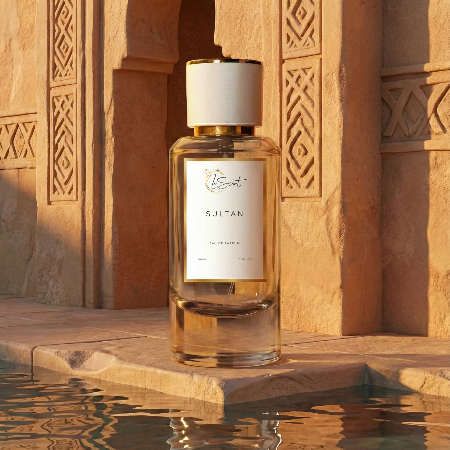 LeScent Sultan inspired perfume bottle standing beside carved Arabian stone architecture with warm sunset lighting and water reflections. Inspired by Al-Jazeera Magic.