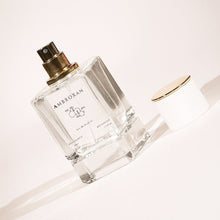 LeScent Perfume Primer bottle of Ambroxan with gold spray cap, photographed on a light background