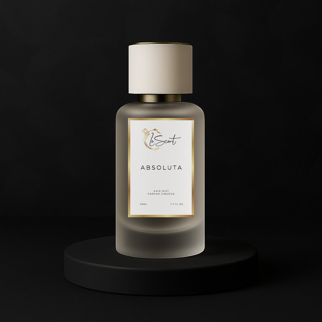 LeScent Absoluta hair fragrance mist bottle on a black pedestal surrounded by pineapple, grapefruit, lemon, and blackcurrant fruits, inspired by Creed Aventus Absolu.