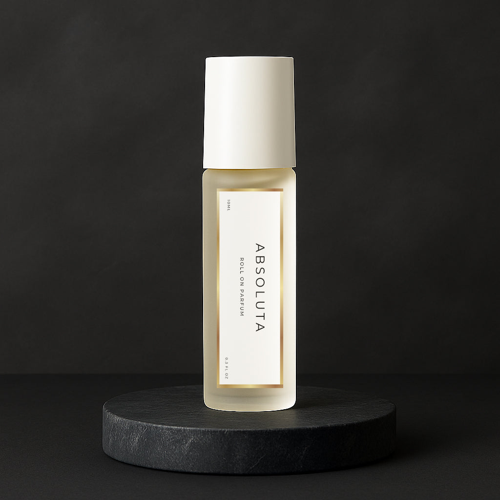 LeScent Absoluta roll-on perfume oil bottle displayed on a sleek black pedestal with soft light reflection, inspired by Creed Aventus Absolu.