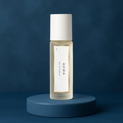 LeScent Agwa roll-on perfume oil bottle placed on a deep navy platform with soft marine-blue background and diffused lighting, inspired by Armani Acqua Di Gio Profondo.