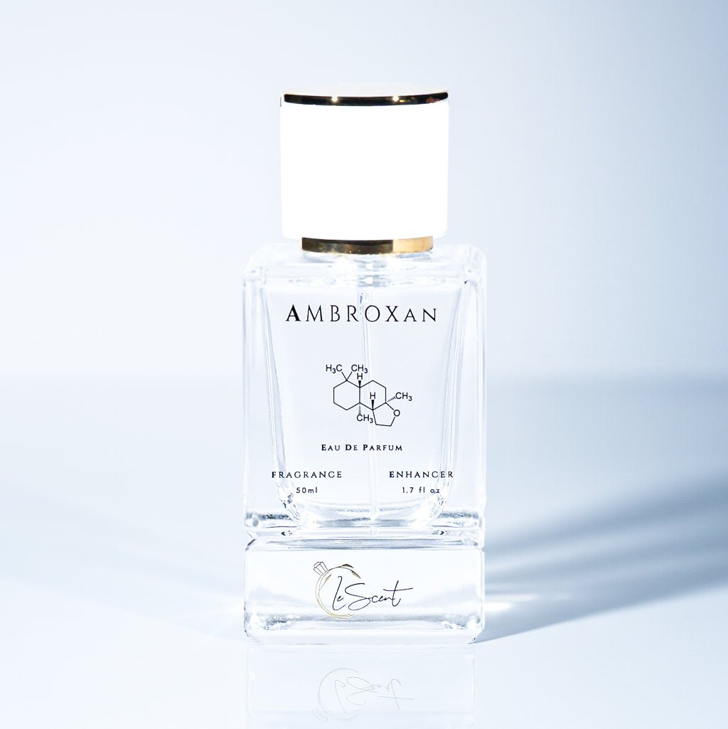 A 50ml bottle of LeScent Ambroxan Fragrance Enhancer, a perfume primer, with the ambroxan chemical structure on the label and a reflection below.