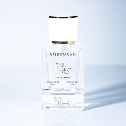 A 50ml bottle of LeScent Ambroxan Fragrance Enhancer, a perfume primer, with the ambroxan chemical structure on the label and a reflection below.