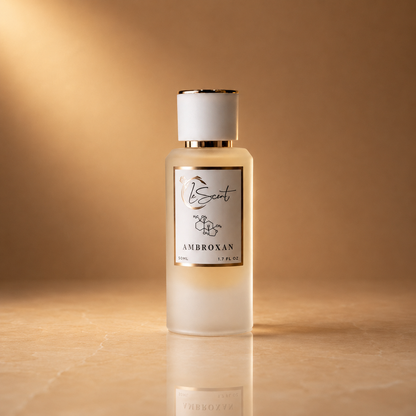 LeScent Ambroxan Molecule Primer in a 50ml frosted glass bottle with gold-trimmed cap, on a warm amber marble surface