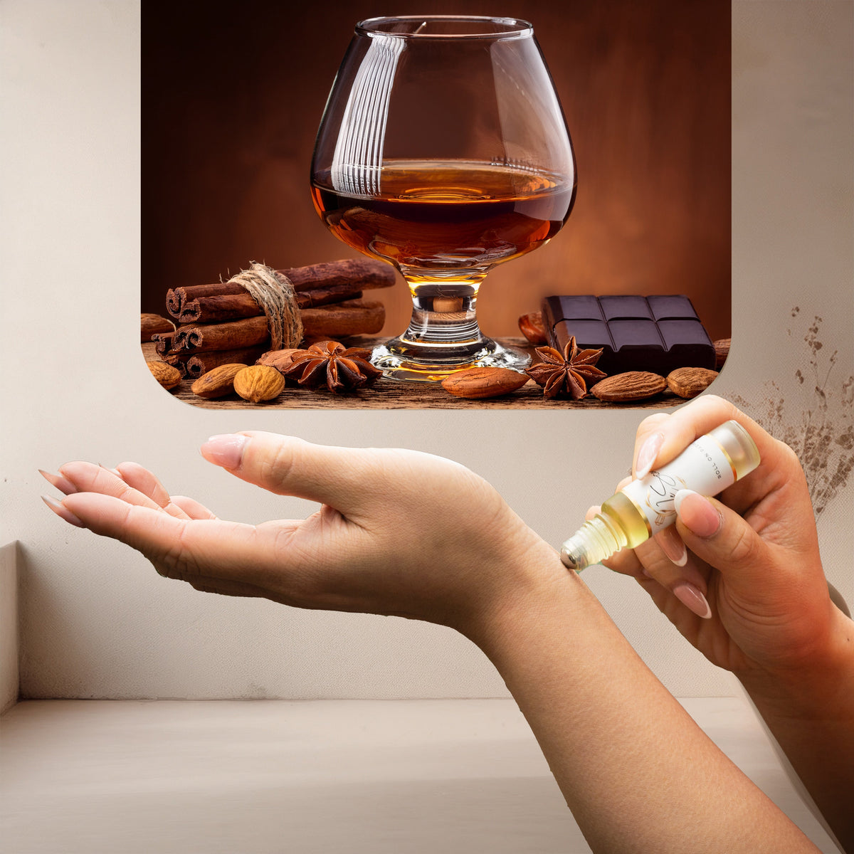 Applying LeScent Angel Roll On Perfume Oil inspired by Kilian Angel Share — smooth amber, cognac and vanilla layers creating a warm spiced scent on skin.