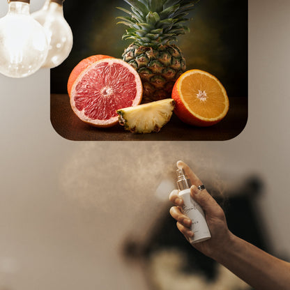 Spraying LeScent Bonaparte Room Spray inspired by Creed Aventus — fresh burst of pineapple, ambergris and birch smoke filling the air with vibrant masculine energy.