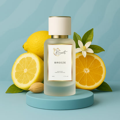LeScent Breeze hair perfume mist bottle surrounded by lemon, orange, neroli flowers, and cardamom pods against a cool blue background, inspired by Louis Vuitton Imagination.