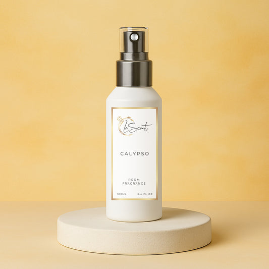 LeScent Calypso room fragrance spray bottle presented on a soft beige pedestal with a smooth golden background and gentle ambient lighting, inspired by Vilhelm Parfumerie Mango.