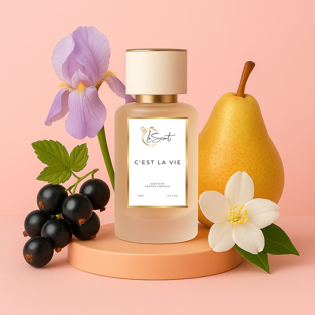 LeScent C’est La Vie hair perfume mist and hair fragrance bottle with pear, iris flower, blackcurrant berries and white blossom arranged as visual ingredients behind it, inspired by Lancôme La Vie Est Belle.