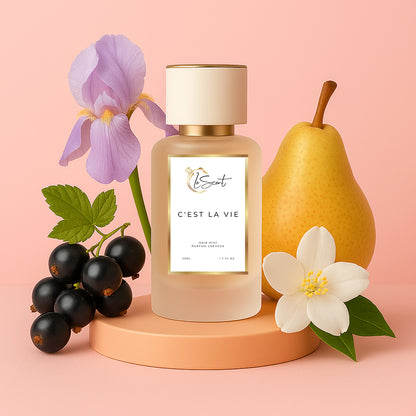 LeScent C’est La Vie hair perfume mist and hair fragrance bottle with pear, iris flower, blackcurrant berries and white blossom arranged as visual ingredients behind it, inspired by Lancôme La Vie Est Belle.