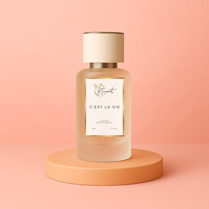 LeScent C’est La Vie hair perfume, hair fragrance and hair perfume mist bottle on a soft coral background, inspired by Lancôme La Vie Est Belle.