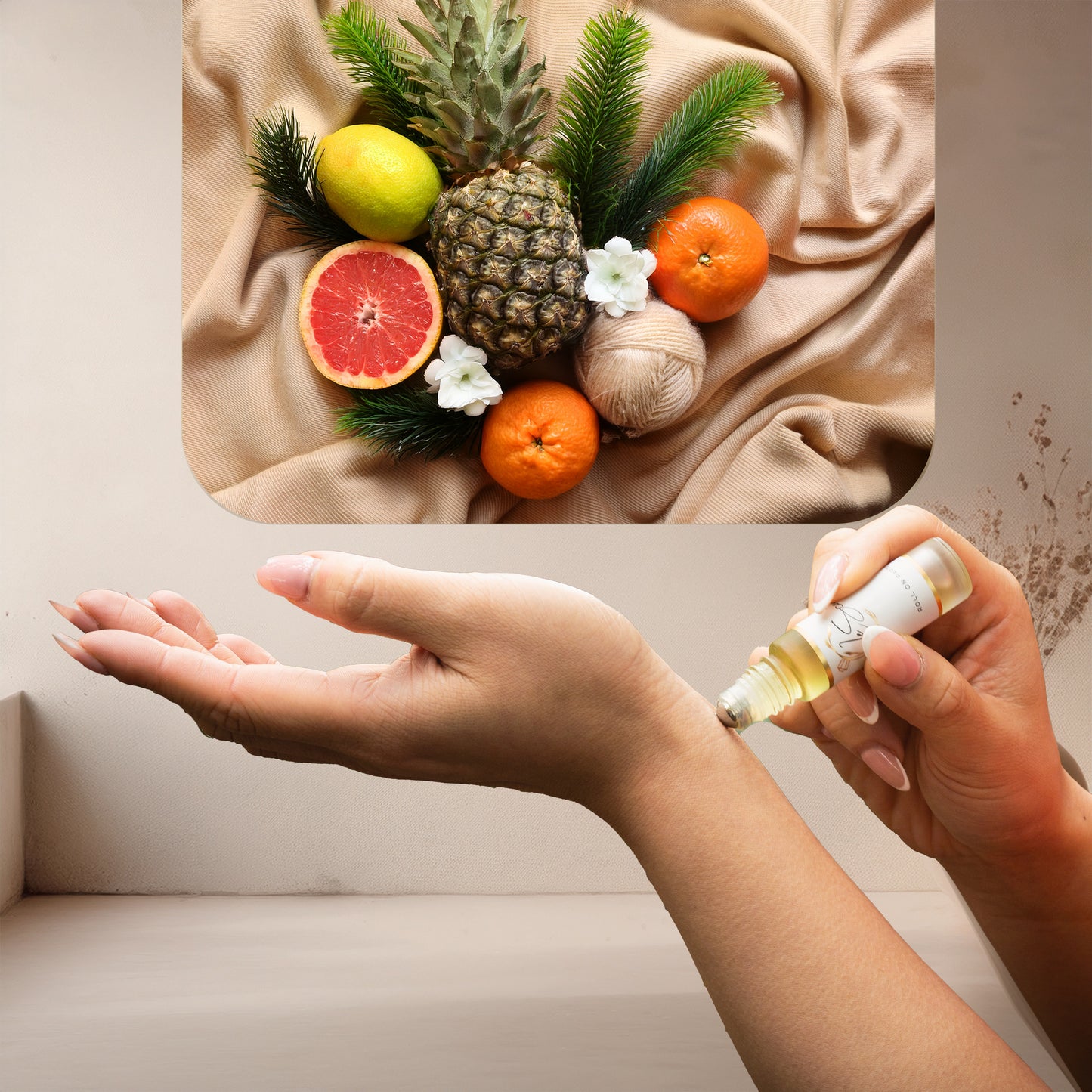 Applying LeScent Chypre roll-on perfume oil beside pineapple, grapefruit, mandarin, and pine leaves on a warm neutral fabric, inspired by Nishane Hacivat.