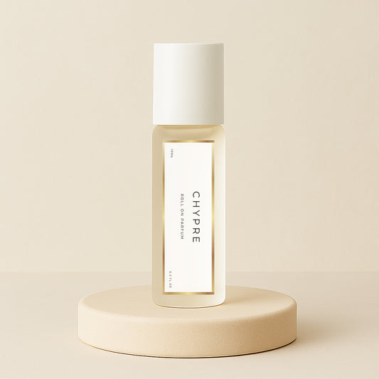 LeScent Chypre roll-on perfume oil bottle displayed on a soft beige pedestal with warm neutral background and golden tones, inspired by Nishane Hacivat.