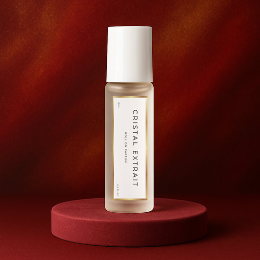LeScent Cristal Extrait roll-on perfume oil bottle standing on a red velvet platform with soft spotlight and warm gradient background, inspired by Maison Francis Kurkdjian Baccarat Rouge 540 Extrait.