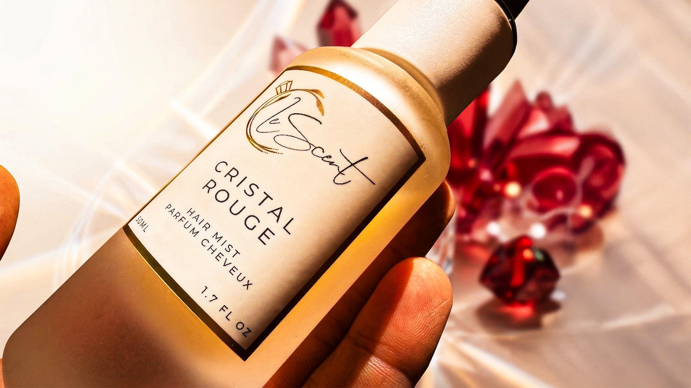 Close-up of LeScent Cristal Rouge hair mist and hair perfume with warm, golden lighting.