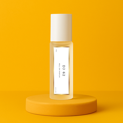 LeScent DJ 62 roll-on perfume oil bottle displayed on a vibrant golden yellow pedestal with sunlit tones, inspired by Sol de Janeiro Brazilian Crush Cheirosa 62.