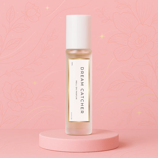 Luxury roll on perfume oil, parfum oil roller and roll on fragrance bottle standing on a soft pink platform with a floral background, inspired by Louis Vuitton Attrape Rêves.