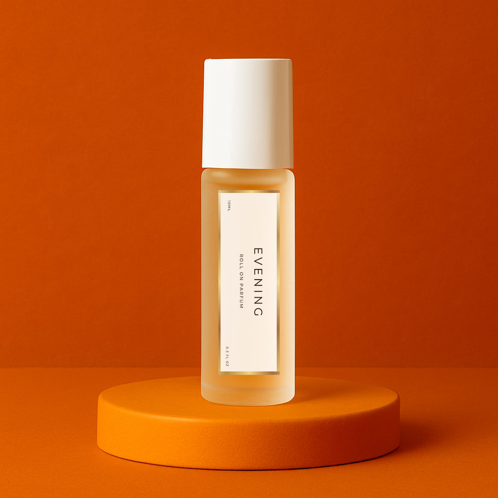 LeScent Evening perfume oil roll-on bottle on an orange pedestal with a solid orange background, inspired by Maison Francis Kurkdjian Grand Soir.