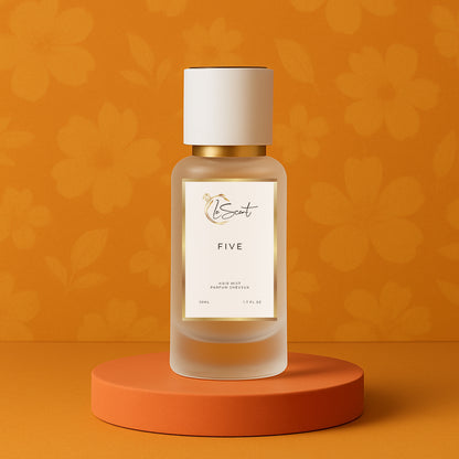 LeScent Five hair mist bottle on an orange pedestal with a floral background, inspired by Chanel No.5.