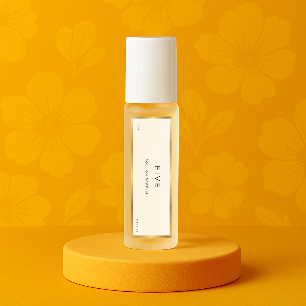 LeScent Five perfume oil roll-on bottle on a yellow pedestal with a floral background, inspired by Chanel No.5.