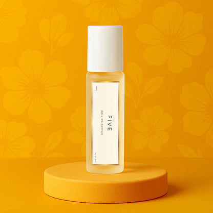 LeScent Five perfume oil roll-on bottle on a yellow pedestal with a floral background, inspired by Chanel No.5.