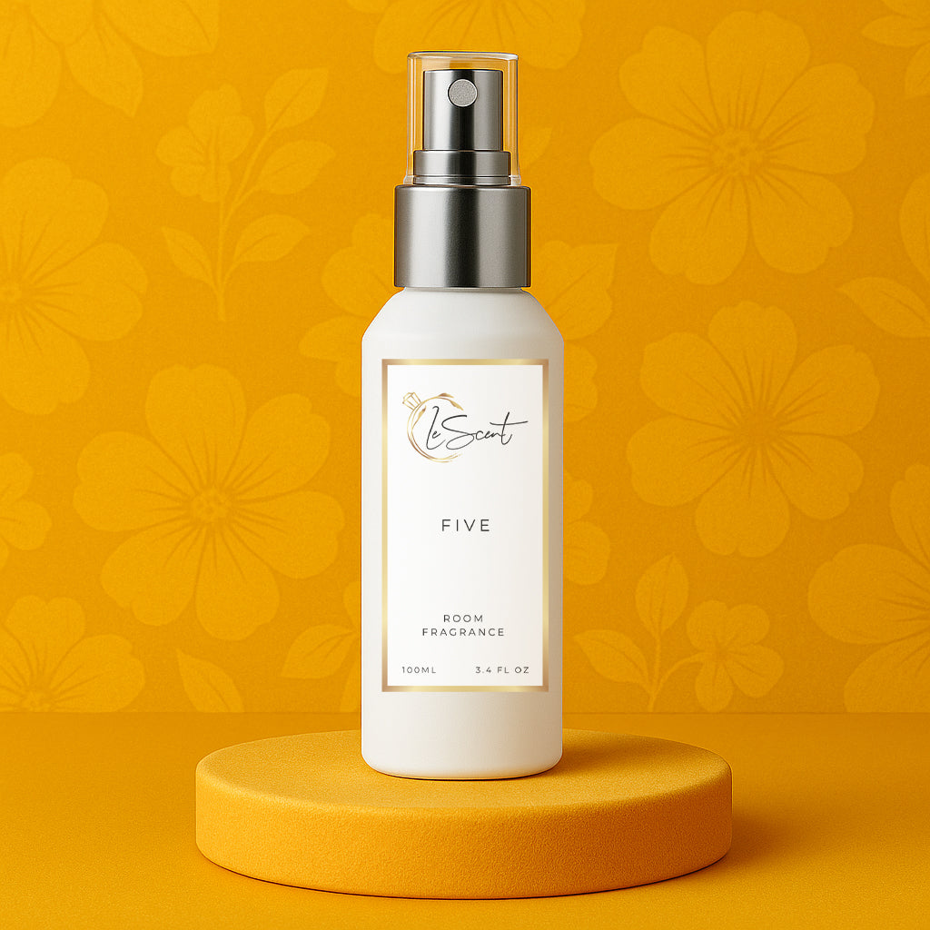 LeScent Five room spray bottle on a yellow pedestal with a floral background, inspired by Chanel No.5.