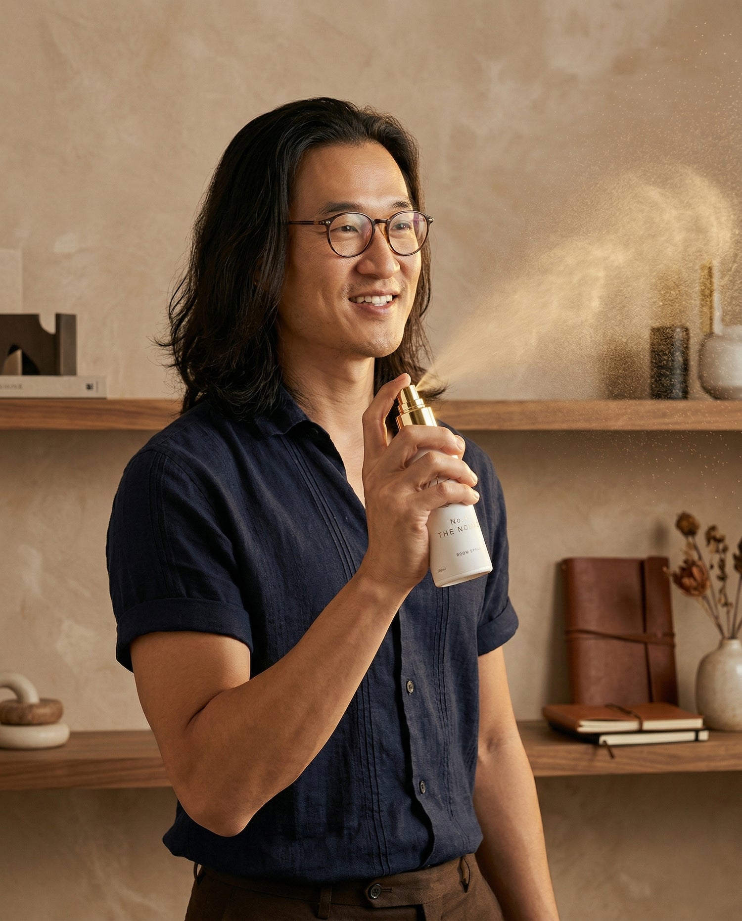 Man holding a bottle of hair product in a home setting