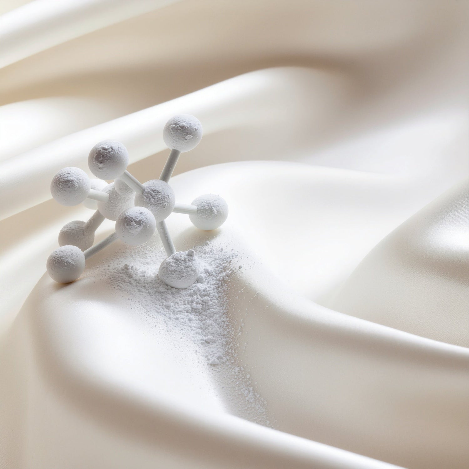 White molecular structure and powder on silky fabric, symbolizing purity, innovation, and the science behind fragrance formulation.