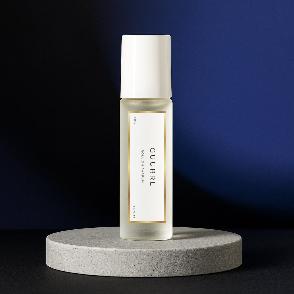 LeScent Guurrl perfume oil roll-on bottle on a grey pedestal with a dark blue and black background, inspired by Carolina Herrera Good Girl.