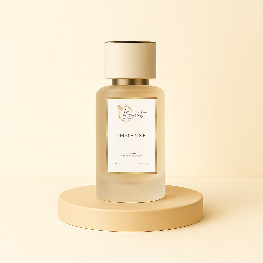 LeScent Immense hair perfume, hair fragrance, hair perfume mist bottle on a beige pedestal with a warm neutral background, styled as a clean hero presentation, inspired by Louis Vuitton L’Immensité.