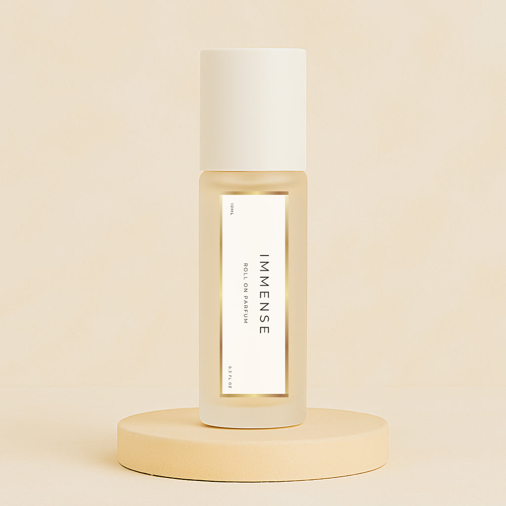 LeScent Immense perfume oil roll-on bottle on a soft beige pedestal with a matching warm beige background, captured as a clean minimal hero shot, inspired by Louis Vuitton L’Immensité.