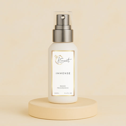 LeScent Immense room spray bottle on a beige pedestal with a soft neutral background, photographed as a clean studio hero image, inspired by Louis Vuitton L’Immensité.