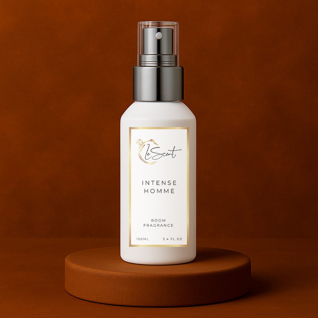 LeScent Intense Homme room fragrance spray bottle placed on a matte brown pedestal with warm amber-toned background and soft light gradient, inspired by Dior Homme Intense.