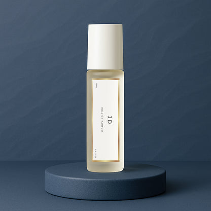 LeScent JD perfume oil roll-on bottle on a dark blue pedestal with a solid dark blue background, inspired by Dior Sauvage EDP.