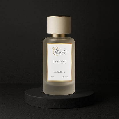 LeScent Leather hair mist bottle on a black pedestal with a solid black background, inspired by Tom Ford Ombre Leather.