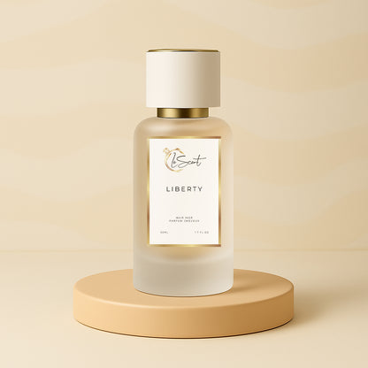 LeScent Liberty hair fragrance mist bottle on a warm beige pedestal with a soft patterned backdrop and smooth studio lighting, inspired by Yves Saint Laurent Libre.