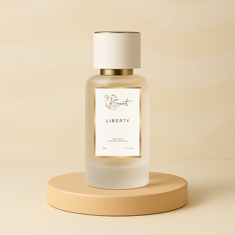LeScent Liberty hair fragrance mist bottle on a warm beige pedestal with a soft patterned backdrop and smooth studio lighting, inspired by Yves Saint Laurent Libre.