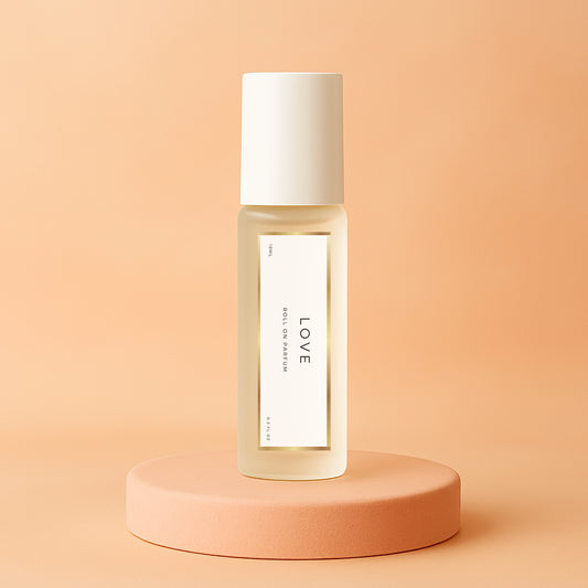 LeScent Love roll-on perfume oil bottle standing on a soft peach platform with warm beige background and diffused glow, inspired by Armani Si.