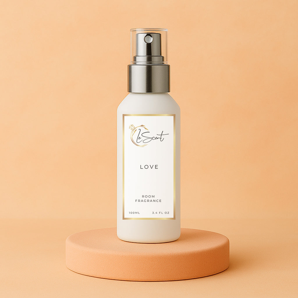 LeScent Love room fragrance spray bottle placed on a peach-toned pedestal with matching warm pastel background, inspired by Armani Si.