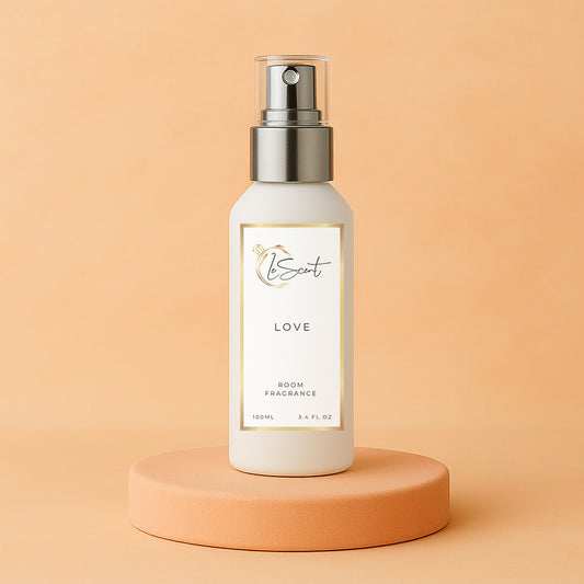 LeScent Love room fragrance spray bottle placed on a peach-toned pedestal with matching warm pastel background, inspired by Armani Si.