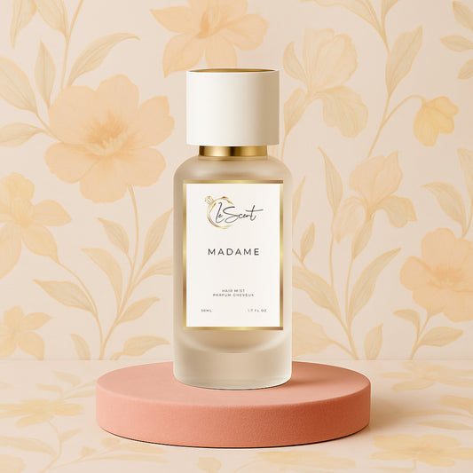 LeScent Madame hair mist bottle on a pink pedestal with a floral background, inspired by Chanel Coco Mademoiselle.