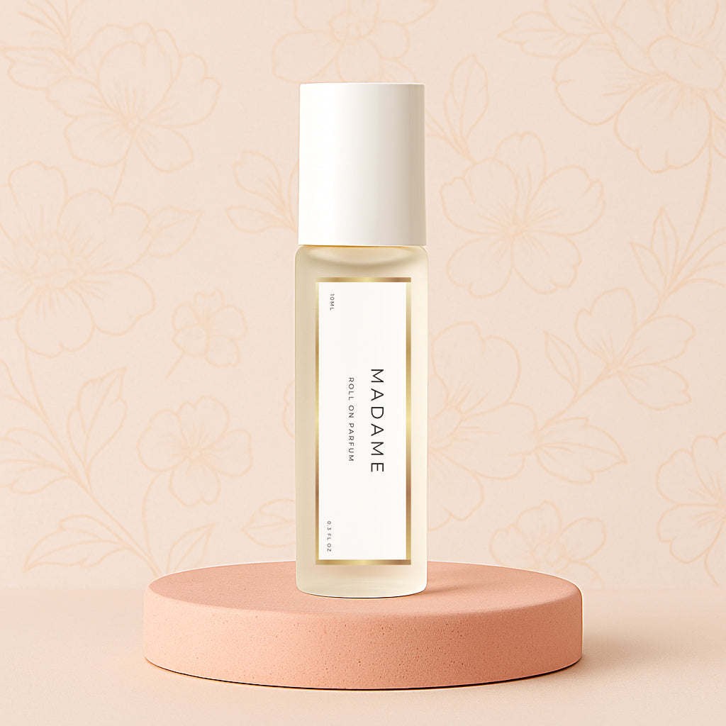 LeScent Madame perfume oil roll-on bottle on a pink pedestal with a floral background, inspired by Chanel Coco Mademoiselle.