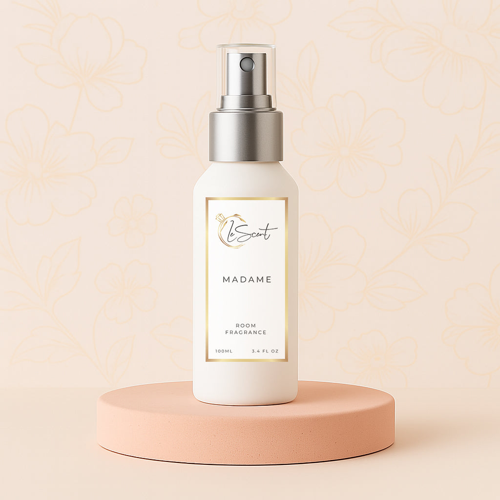 LeScent Madame room spray bottle on a pink pedestal with a floral background, inspired by Chanel Coco Mademoiselle.