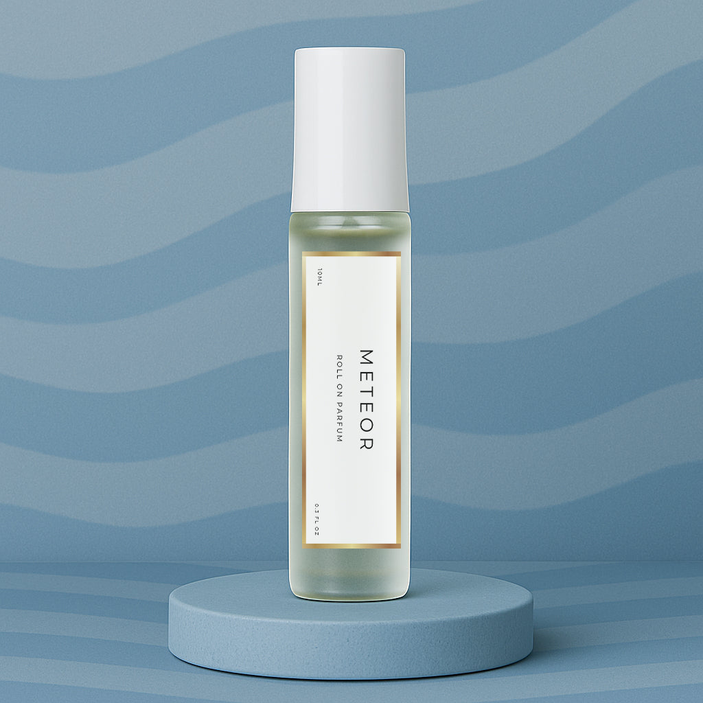 LeScent Meteor roll on perfume oil, parfum oil roller, roll on fragrance bottle standing on a blue platform with a soft blue background, inspired by Louis Vuitton Météore.