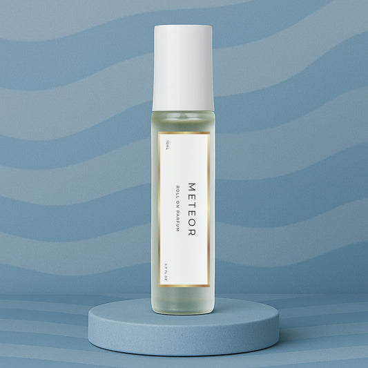 LeScent Meteor roll on perfume oil, parfum oil roller, roll on fragrance bottle standing on a blue platform with a soft blue background, inspired by Louis Vuitton Météore.