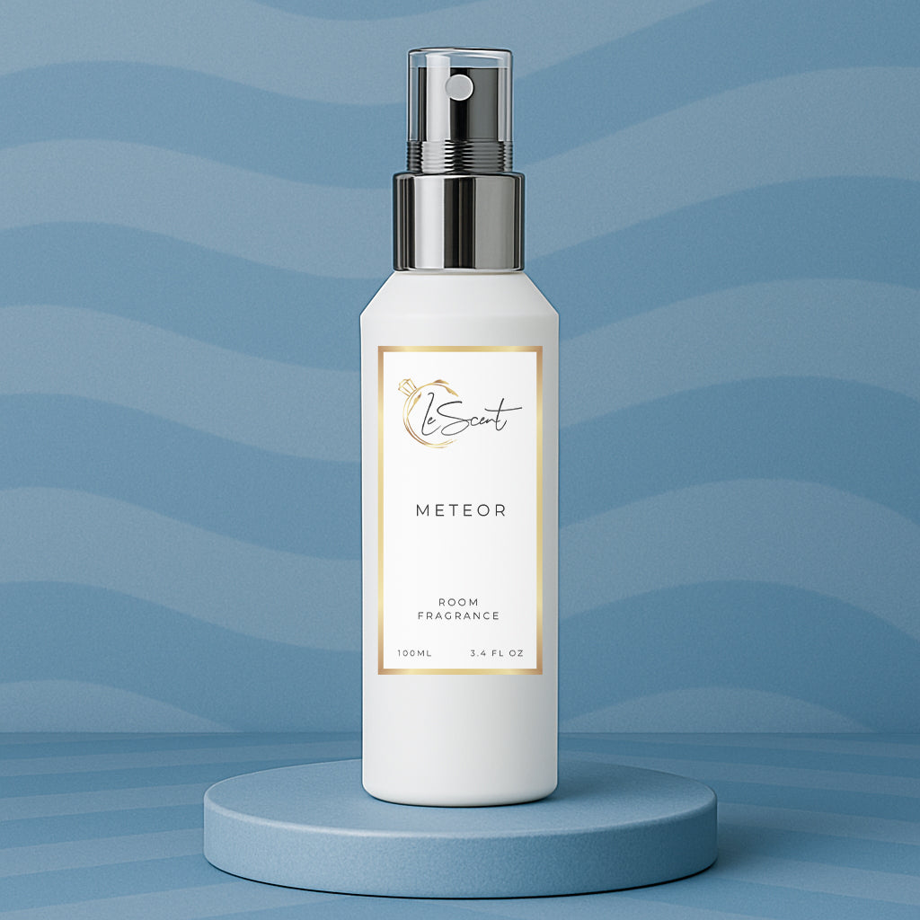LeScent Meteor room spray, room fragrance, home fragrance freshener mist bottle displayed on a blue platform with a soft wave-pattern blue background, inspired by Louis Vuitton Météore.