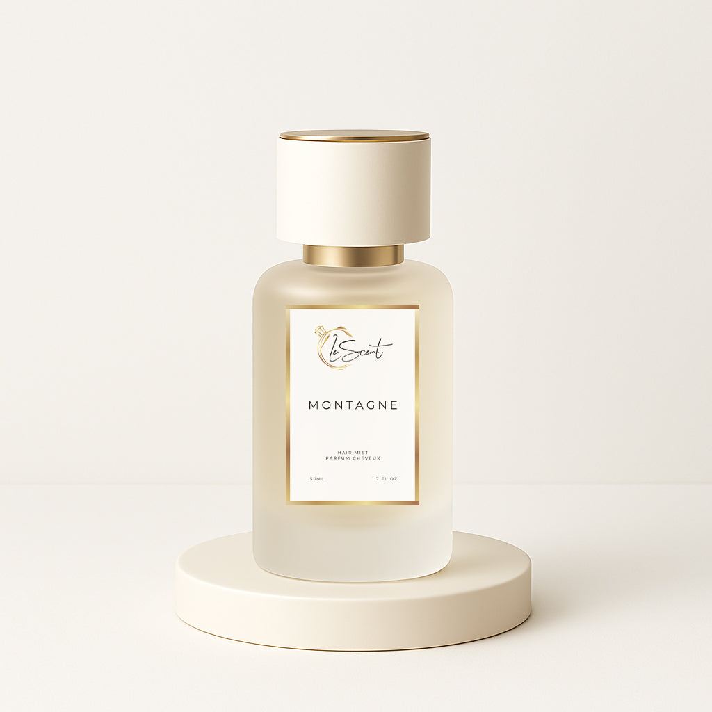 LeScent Montagne hair perfume mist bottle on a cream pedestal with a soft off-white background, photographed for a clean hero presentation, inspired by Creed Silver Mountain Water.