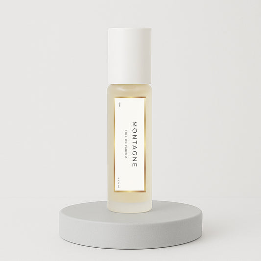 LeScent Montagne perfume oil roll-on bottle on a clean white pedestal with a soft white background, photographed for a minimalist hero presentation, inspired by Creed Silver Mountain Water.