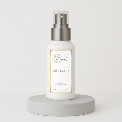 LeScent Montagne room spray bottle on a clean grey pedestal with a white background, styled for a modern hero product shot, inspired by Creed Silver Mountain Water.